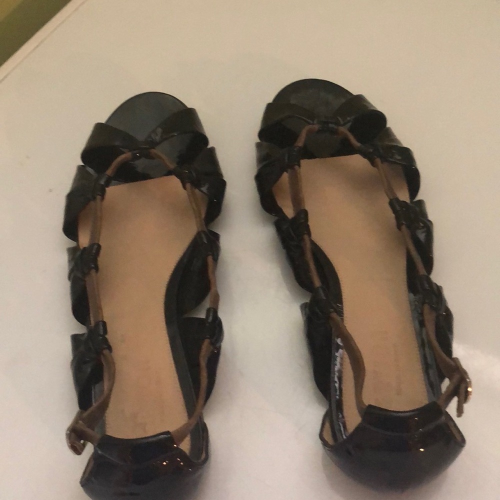 Great black patent leather with brown leather strap to open .